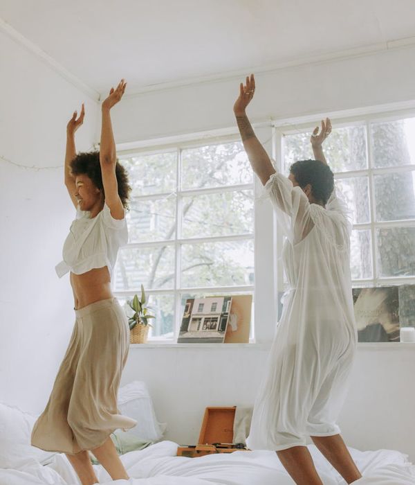 Woman feeling energized and happy in a bright, airy space.